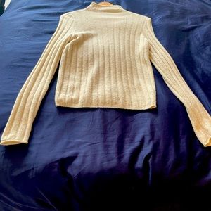 Trendy turtleneck. Sheer fit for a sexy look. Wear a cami underneath.